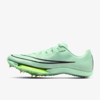 A pair of green shoes with spikes on them.