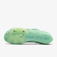 A pair of green shoes with spikes on the side.
