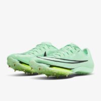 A pair of green shoes with spikes on them.