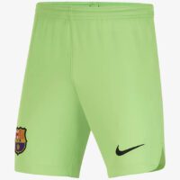 A pair of green nike shorts with the fc barcelona logo on it.
