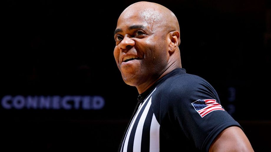 A referee smiling for the camera.